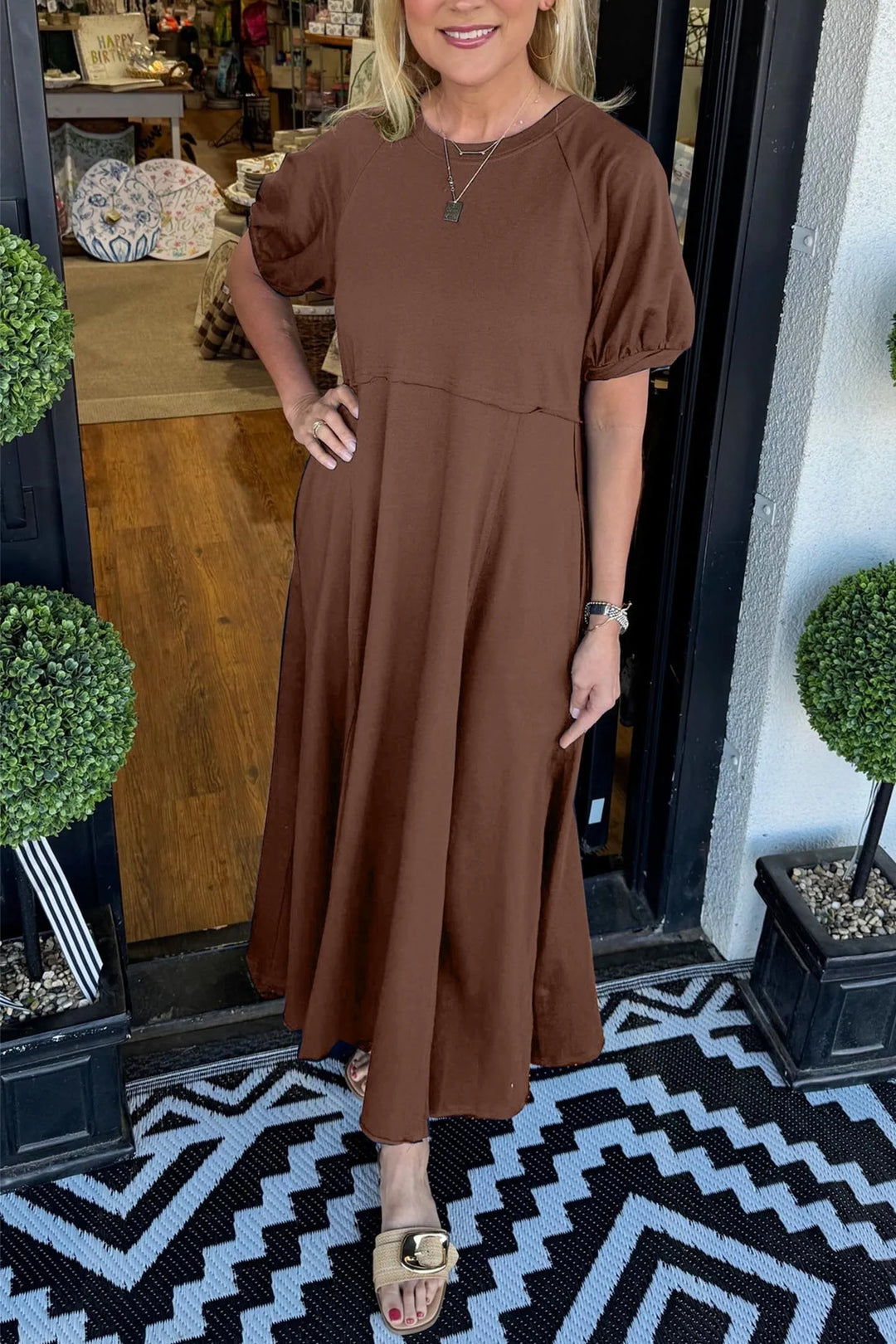 A chic long dress with a round neckline and puff sleeves