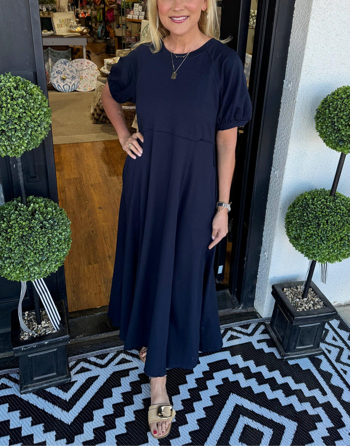 A chic long dress with a round neckline and puff sleeves